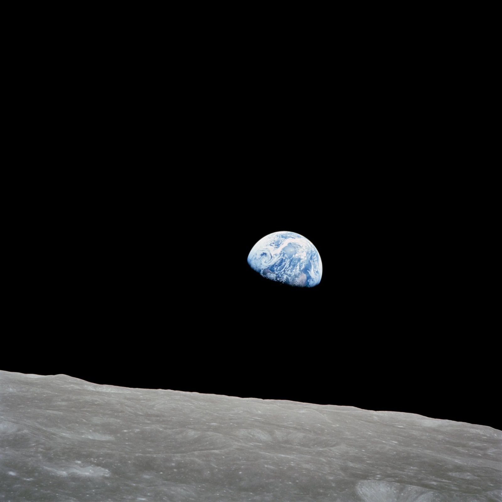 Taken aboard Apollo 8 by Bill Anders, this iconic picture shows Earth peeking out from beyond the lunar surface as the first crewed spacecraft circumnavigated the Moon. - NASA